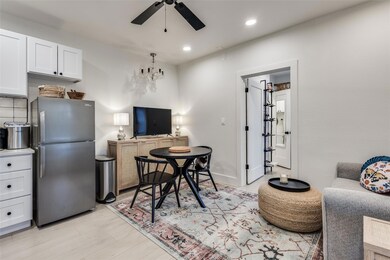 Living area with ceiling fan with notable chandeli