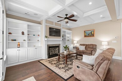 Living room featuring beamed ceiling, dark hardwoo