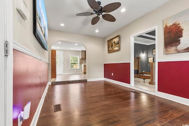 Spare room featuring recessed lighting, wood finished floors, arched walkways, and a ceiling fan