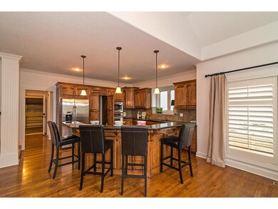 Large granite island with eating bar, hardwood flo