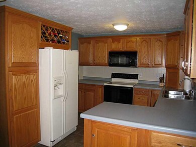 Kitchen. The kitchen has a wine rack, new garbage 