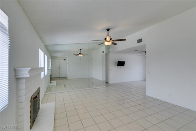 Unfurnished living room featuring a ceiling fan, a