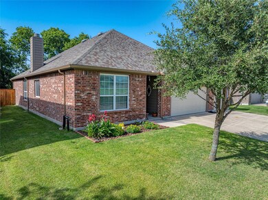 Ranch-style home featuring a garage and a front yard