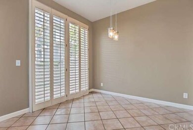Dining room with beautiful pendant lighting and sl