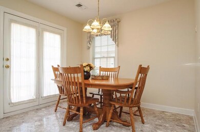 Eating area accomodates a large table.  Access to the deck here through the french doors.