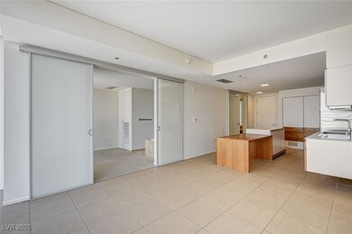 Kitchen with butcher block countertops, light tile patterned flooring, a center island, and white cabinets