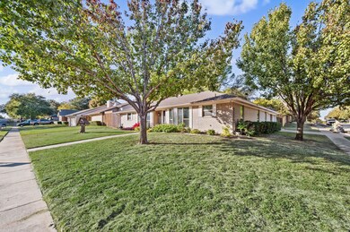 View of front of house with a front yard and brick siding