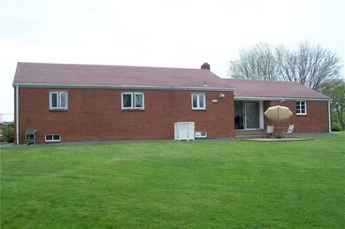 REAR VIEW OF THE HOME SHOWING PATIO OFF BREEZEWAY.