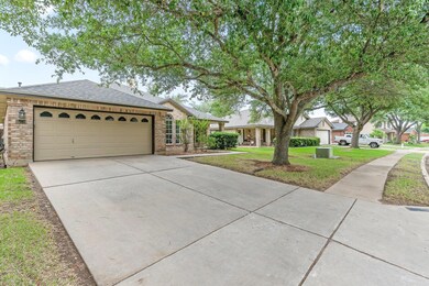 Ranch-style home with concrete driveway, brick si