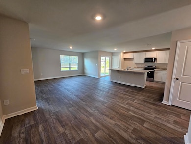 Kitchen with stainless steel appliances, open floo