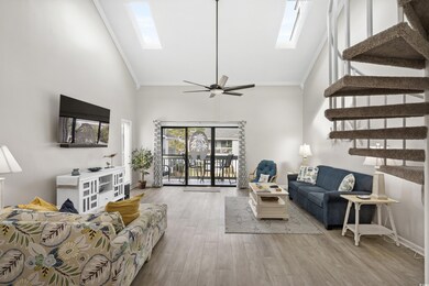 Living room featuring ceiling fan, light hardwood 