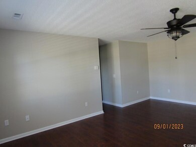 Spare room featuring ceiling fan and hardwood / wood-style floors