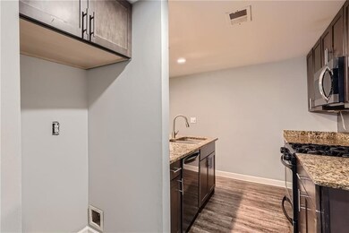 Kitchen with light stone countertops, stainless st
