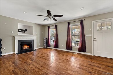 Unfurnished living room featuring dark hardwood /