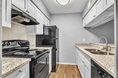 Kitchen w- granite counters & black appliances