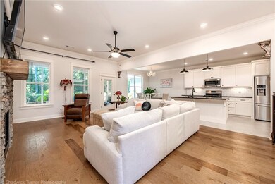 Plenty of large windows let in loads of natural beauty, provided by the private backyard