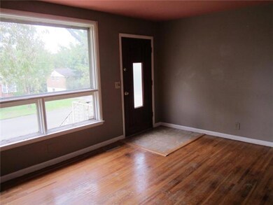 | Living room w/ large windows | hardwood floors |