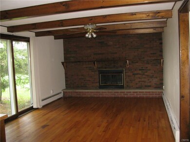 Family room with wood burning fireplace. Slider op