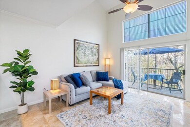 Living room with a towering ceiling, baseboards, 