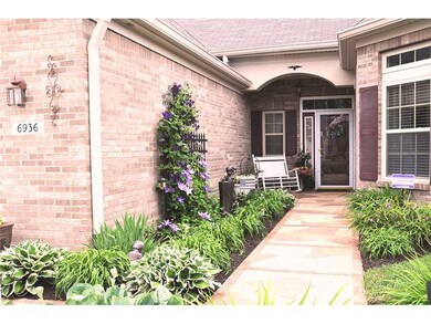 Exterior Front. Professional landscaping and plants, custom design concrete walkway welcomes you to the front door.