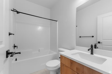 Full bathroom with bathing tub / shower combination, vanity, and light tile patterned floors