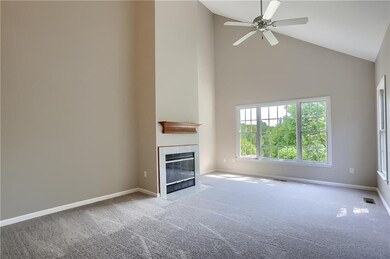 The open family room boasts a two story vaulted ce
