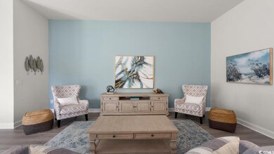 Living area featuring baseboards and dark wood-type flooring
