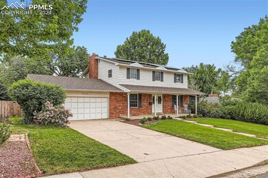View of property with a front yard and a garage