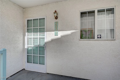Entrance to property with stucco siding