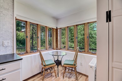 Sunroom featuring radiator heating unit, wood finished floors, and french doors