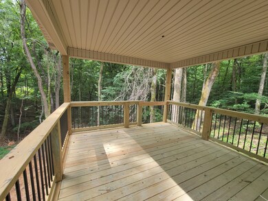This covered back deck is your personal tree house to watch the wildlife in the woods!