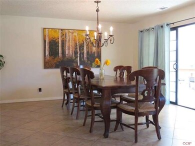 Large dining room with a slider to the sunroom.