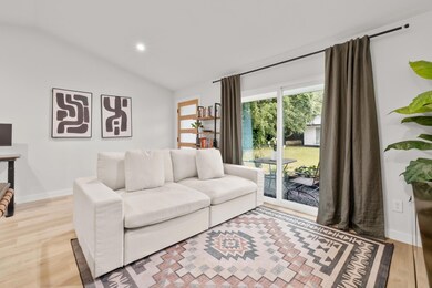 Living area with lofted ceiling, light wood-style