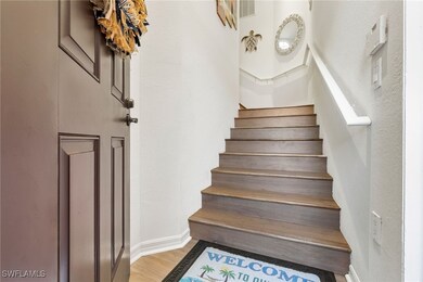 Staircase featuring a textured wall and wood finished floors