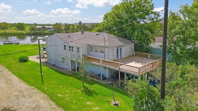 Side view of 1426 Angle Rd showcasing a generously sized, 2nd level deck.