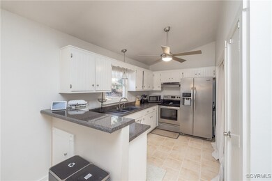 Kitchen with bar area and stainless steel applianc