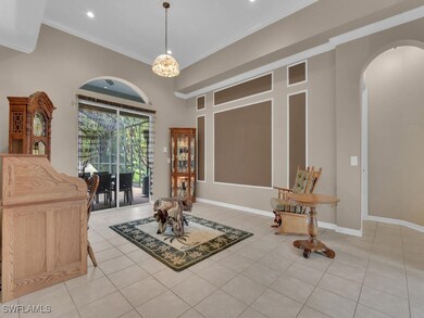 Tiled foyer featuring a chandelier and ornamental
