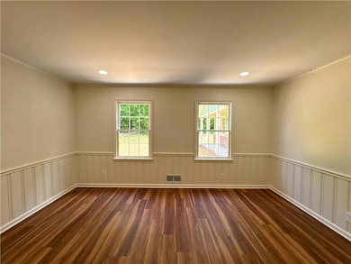 Unfurnished room featuring visible vents, crown mo