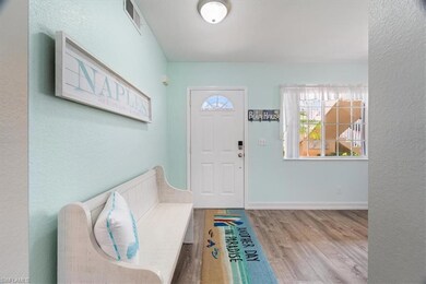 Entryway with wood finished floors and a textured wall