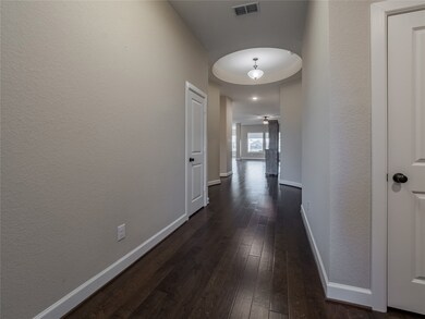 your elegant foyer with beautiful wood floors and