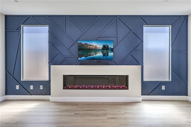 Unfurnished living room with a decorative wall, ba