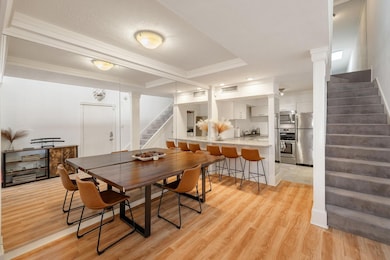 Dining space featuring light wood-style floors, de