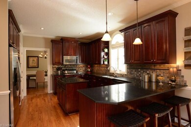 This stunning kitchen has an island and a peninsula for plenty of prep area