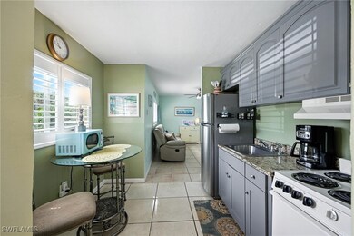 Kitchen featuring under cabinet range hood, light