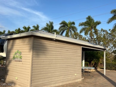 View of side of property featuring metal roof