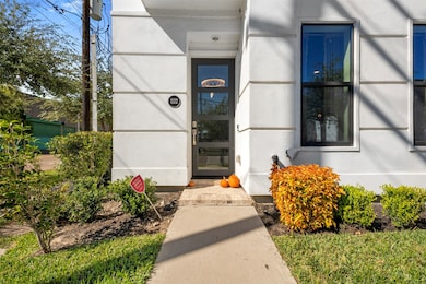 A beautifully landscaped entry welcomes you home with vibrant greenery and elegant curb appeal. The stylish front door sets the tone for the modern luxury inside.