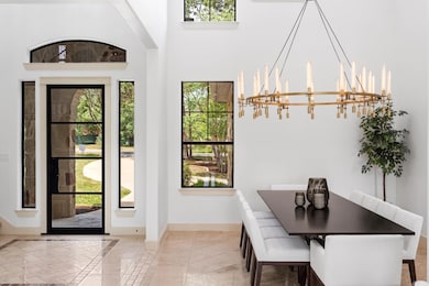 Dining room with a chandelier and a towering ceil