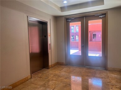 Entrance foyer with elevator, stone tile flooring,