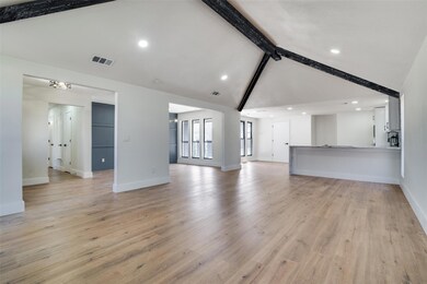 Unfurnished living room featuring lofted ceiling w