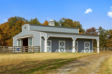 The barn is one of the four outbuildings on the property. The estate also features a tobacco barn, run-in shed for the horses, and an equipment shed that has two dog houses leading to their separate runs.
